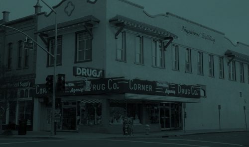 front of corner drug building with green overlay