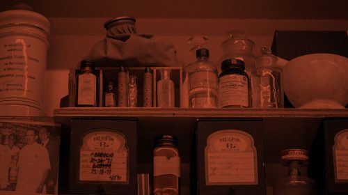 a reddish image of old medicine bottles on a shelf