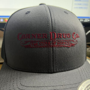 A black baseball cap with the logo Corner Drug Co embroidered on the front.